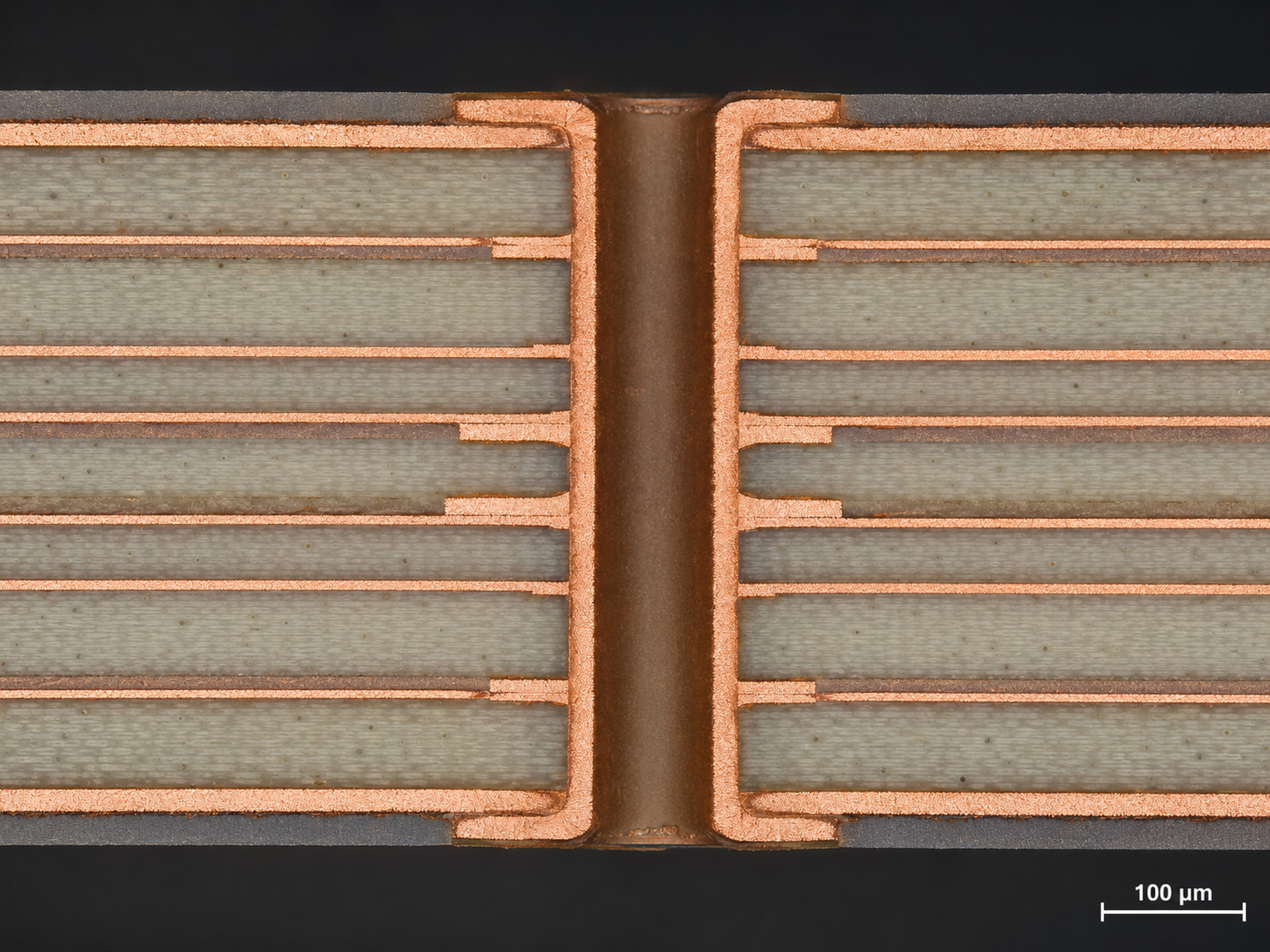 Cross-section micrograph of a multilayer RO4000 PCB showing stable plated through-holes, copper bonding, and dielectric layer structure for high-frequency circuit applications.
